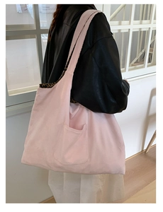 Detail of pink canvas tote bag showing side view with leopard print lining accents
