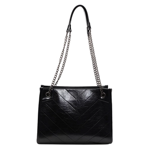Black casual quilted tote bag with double metal chain straps and V-shaped stitching detail