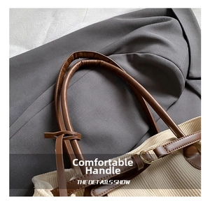 Detail of brown leather handle and beige corduroy fabric on a retro tote bag