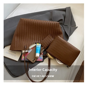 Close-up of brown woven tote bag set with laptop and daily essentials inside