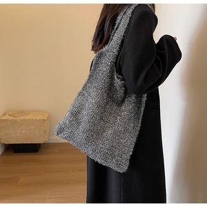 Close-up of silver shimmer knit tote bag showing metallic lurex texture and soft drape