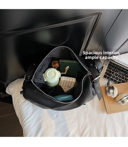 Interior view of black pebbled leather tote bag showing large capacity for essentials