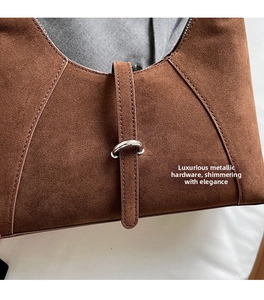 Detail of vintage brown suede bag featuring premium silver ring buckle and fine stitching