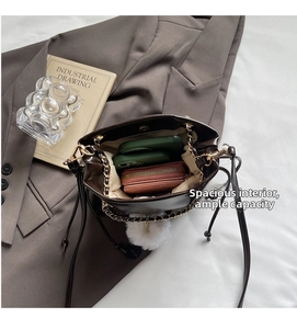 Spacious interior of a brown drawstring bucket bag showing large capacity for essentials