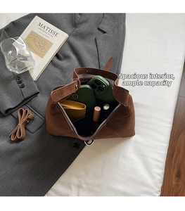 Detail view of the spacious inner compartment of the brown suede minimalist dumpling bag