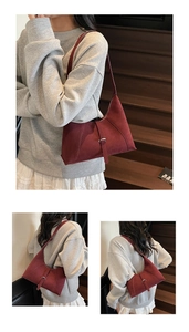 Detail of burgundy suede shoulder bag showing metal buckle and matte texture