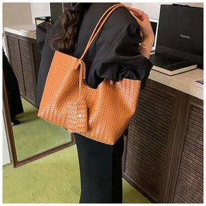 Detail of vintage dark brown woven tote bag showing large capacity and matching small pouch