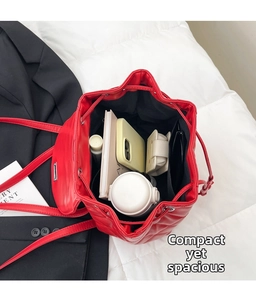 Top view of red quilted drawstring backpack showing large capacity interior with essentials