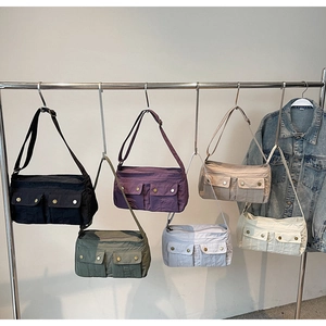 Multi-color utility nylon crossbody bags featuring dual front flap pockets and metallic snaps