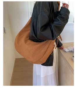 Close-up of caramel suede crossbody bag showing the soft matte texture and large capacity