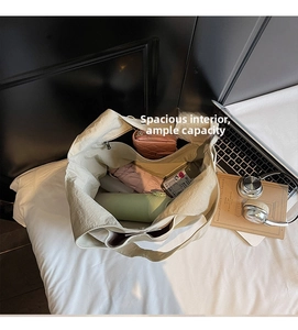 Macro shot of spacious inner compartments of the tote bag holding water bottle and umbrella
