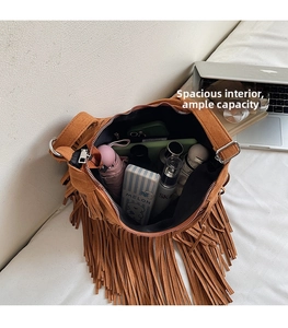 Macro view showing large capacity interior of brown fringe suede shoulder bag for essentials