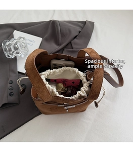 Interior view of brown faux suede bucket bag showing large capacity for phone and wallet