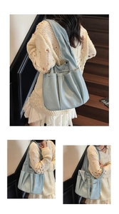 Detail of light blue soft leather tote bag with silver metal bar and pleated texture