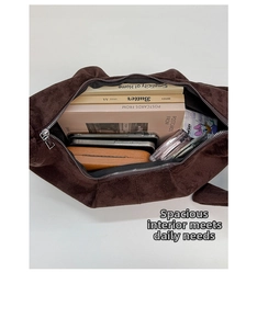 Top view of brown suede dumpling bag showing spacious interior with zipper closure