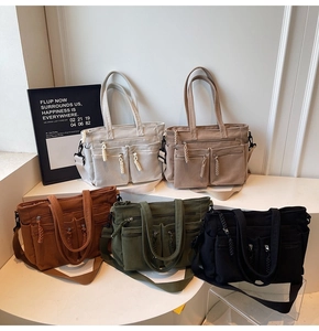 Detail of multi-pocket corduroy tote bags in five colors with wide adjustable straps