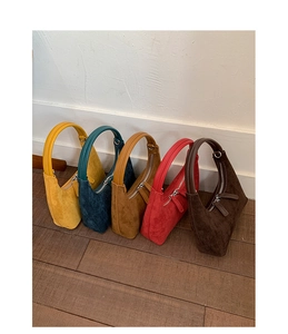 Selection of five suede hobo bags in vibrant colors with leather top handles and zippers