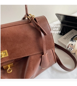 Close-up of vintage brown leather tote bag texture with elegant gold rotating locks