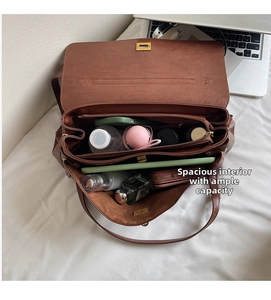 Internal structure of brown leather tote showing multiple spacious storage compartments