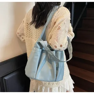Detail of light blue soft PU leather tote bag with side pocket and silver snap button