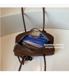 Spacious interior of dark brown suede shoulder bag showing large capacity for essentials