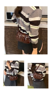 Detail showing brown PU leather shoulder bag with punk rivets and buckle closure
