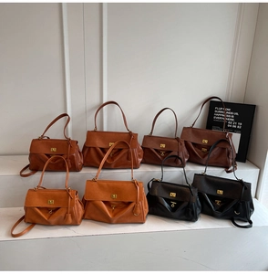 Detail of vintage tote bag featuring premium leather texture and golden metal twist lock