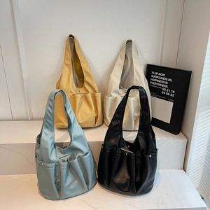 Minimalist soft leather tote bag with multi-pocket design and rivet detail in four colors