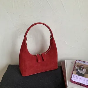 Minimalist red matte moon-shaped hobo handbag with dual silver zippers and leather handle