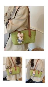Detail of green suede tote bag with brown leather straps and teddy bear charm accessory