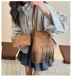 Detail of brown suede bucket bag with fringe tassels and a matching zippered pouch set