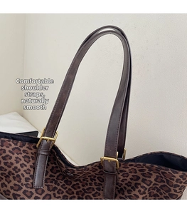 Detailed close-up of brown shoulder straps and vintage gold hardware on leopard tote bag