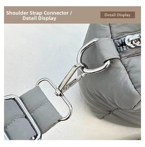 Close-up of durable metal D-ring buckle and quilted padded fabric detail of tote bag