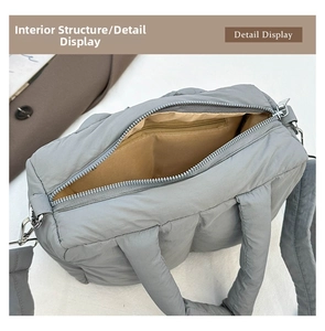Interior view of grey quilted tote bag showing brown lining and zipper pocket details