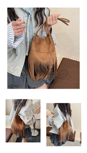 Close-up of brown suede hobo bag with long tassels and soft matte leather texture