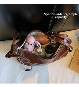 Top view of spacious interior of dark brown faux leather tote bag with various essentials