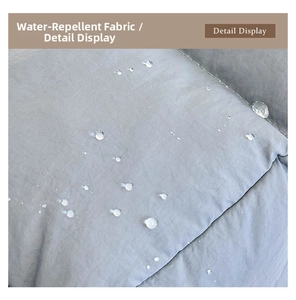 Detailed close-up showing the water-repellent fabric of the grey quilted tote bag