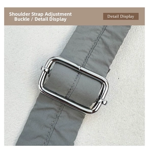 Detail of adjustable silver metal buckle and quilted nylon strap on soft cloud tote bag