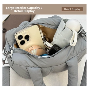 Internal view of a grey quilted puffer bag showing spacious storage for daily items