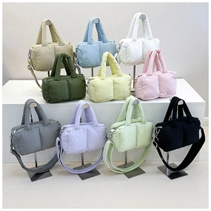 Detailed display of assorted colorful puffer tote bags with quilted texture and straps