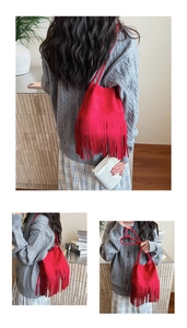 Detail of red tassel bucket bag featuring premium suede texture and long fringe design