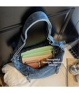Macro view of spacious vintage blue denim dumpling bag showing internal capacity and zip