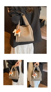 Women PU leather bucket bag stylish shoulder handbag with cute charm for daily commute.