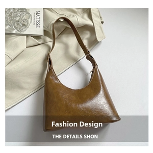 Close-up of brown oiled leather texture and metal buckle on vintage shoulder bag