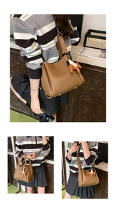 Stylish brown leather bucket bag for women featuring a cute horse charm and comfortable shoulder strap.