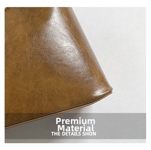 Detailed close-up of glossy brown oil-wax leather texture on a stylish handbag surface