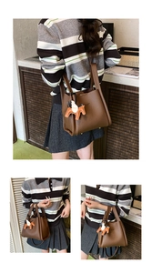 Brown leather bucket bag with horse charm detail, stylish shoulder handbag for women daily wear.