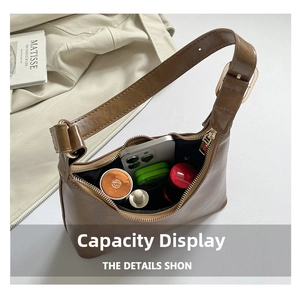 Internal view of the brown retro crescent bag showing space for phone and makeup