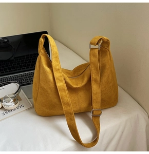 Detail of ginger yellow matte hobo bag with adjustable strap and metal hardware