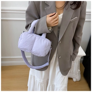 Detailed view of lavender quilted tote bag with soft padded texture and wide shoulder strap